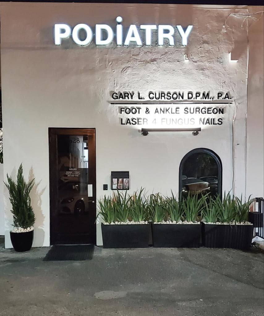 Dr. Gary L. Curson D.P.M., P.A. podiatry office exterior in Miami Beach with signage for foot & ankle surgeon and laser 4 fungus nails treatment